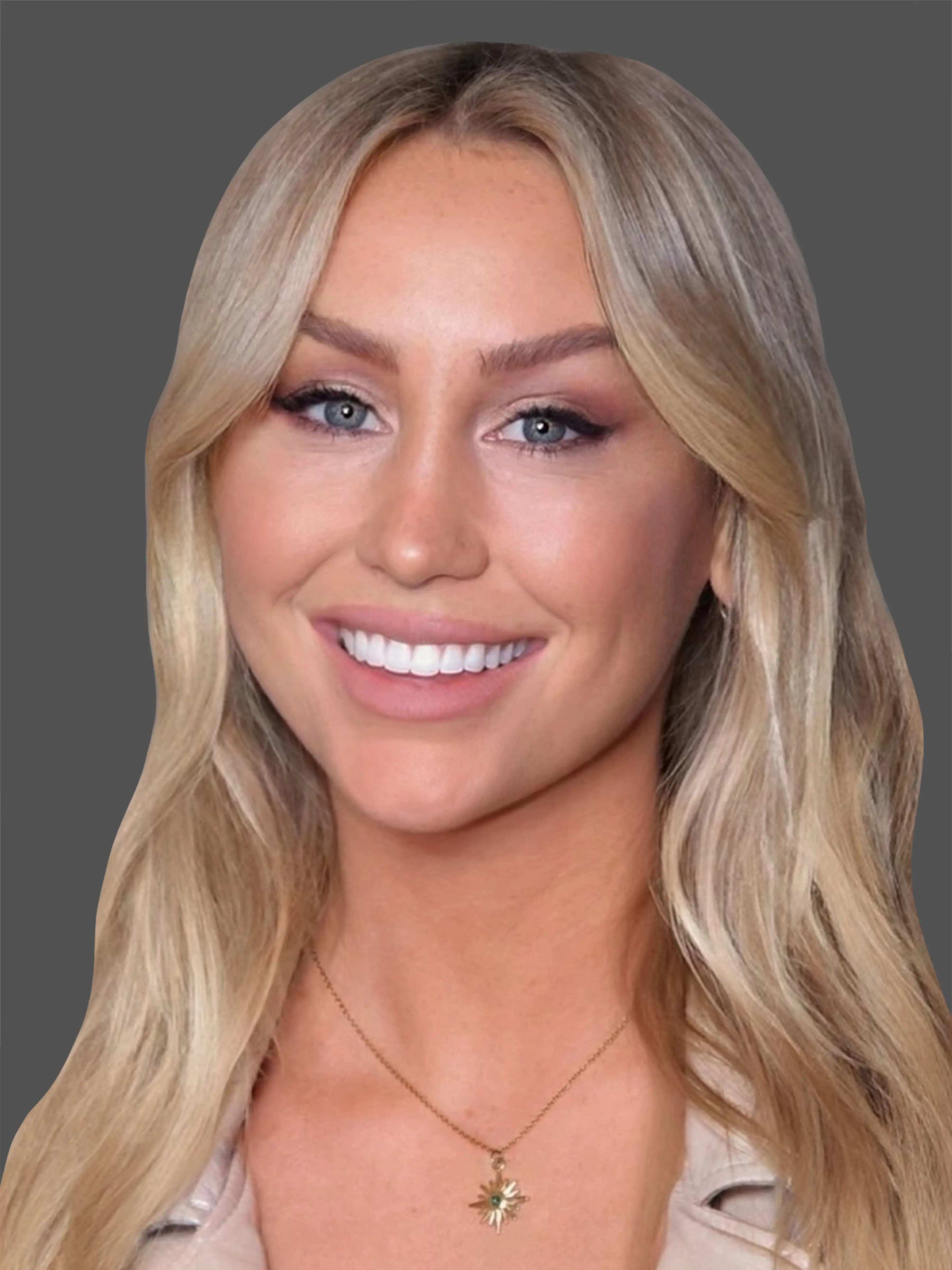 Close-up portrait of Brittany Etherton smiling, with long blonde hair, wearing a gold necklace with a star pendant